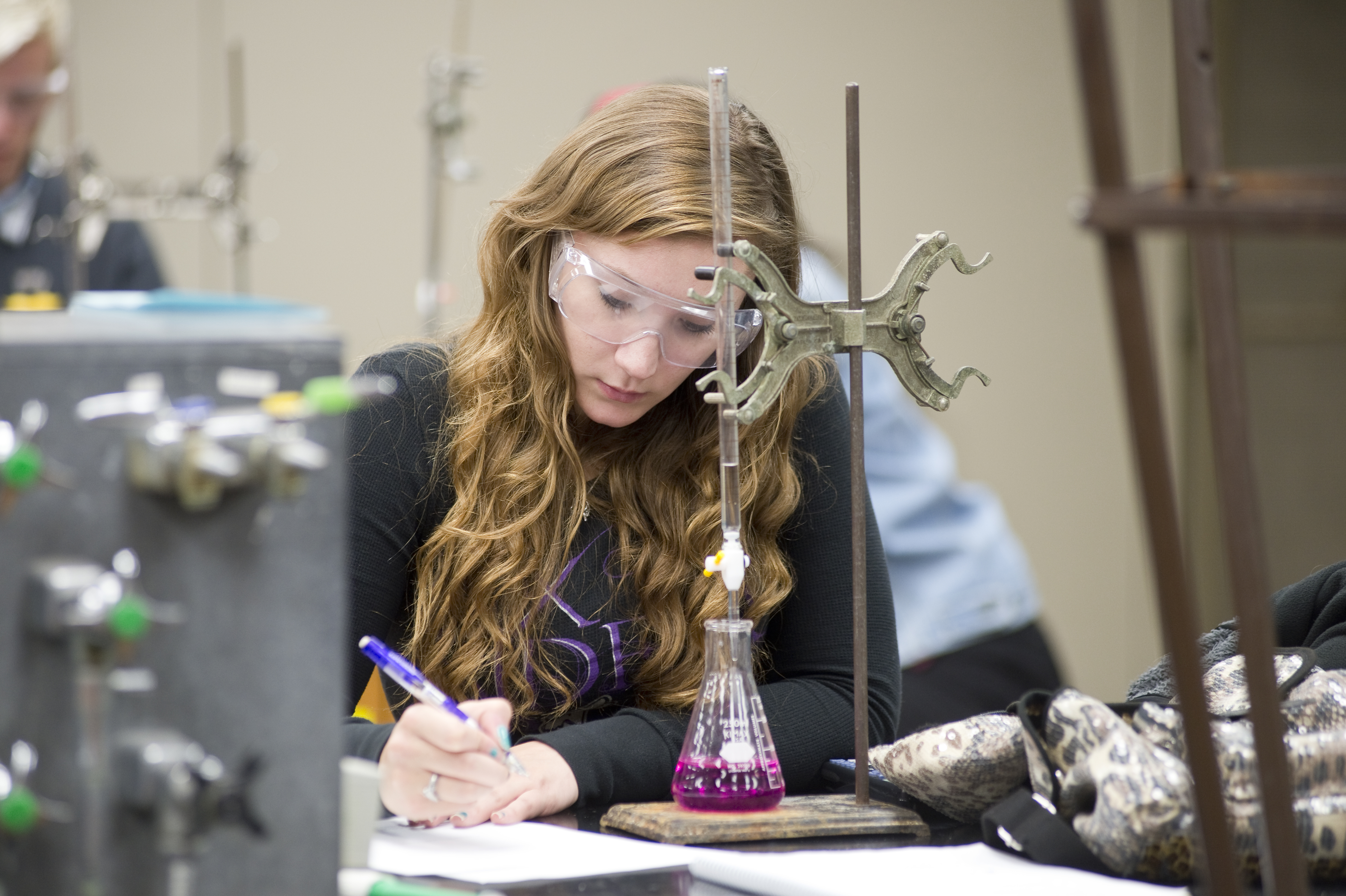 Student studying beaker